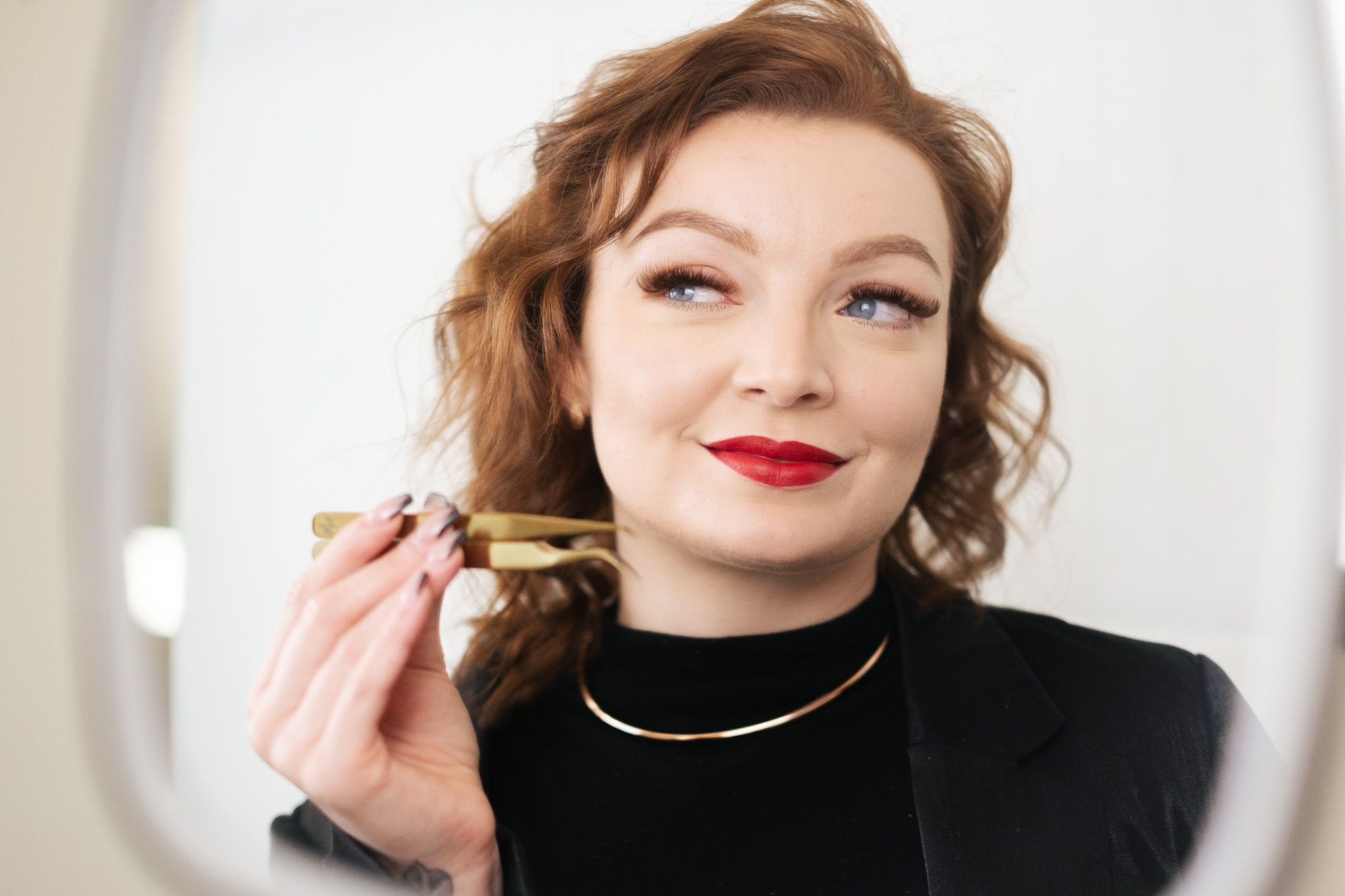 Esthetician Emerald looking in mirror